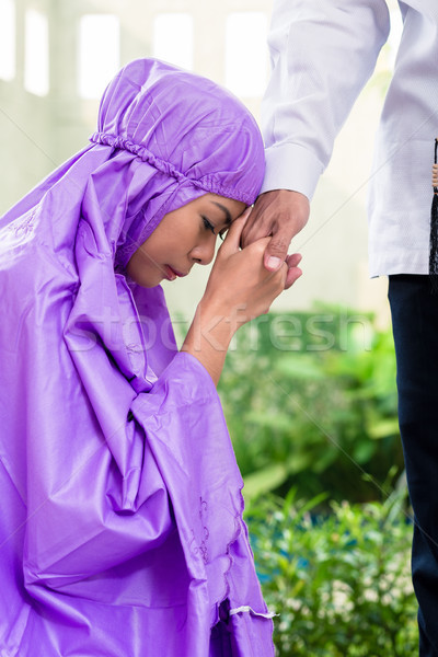Asian Muslim couple, man and woman, praying at home Stock photo © Kzenon