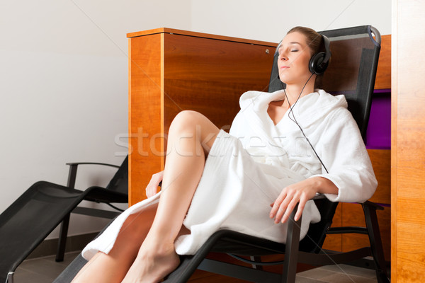 Stock photo: Young woman relaxing in spa with music