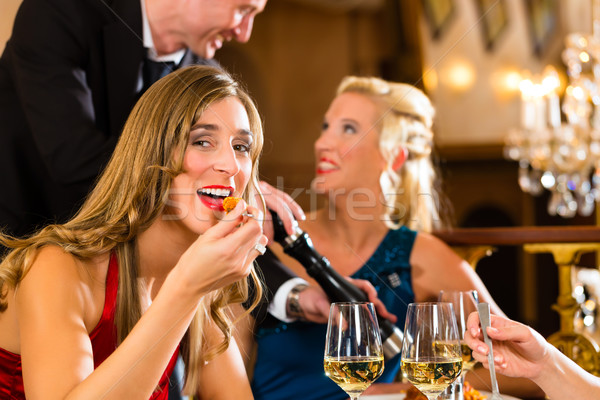 Waiter spices the dinner in a fine restaurant Stock photo © Kzenon