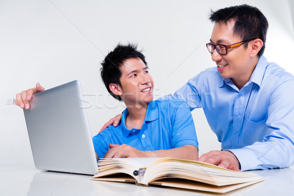 Stock photo: Asian father and son learning at home for school