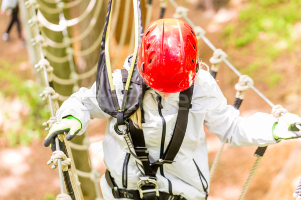 Girl seen from above climbing in high rope course Stock photo © Kzenon