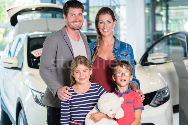 Family with children buying new car at auto dealership  Stock photo © Kzenon