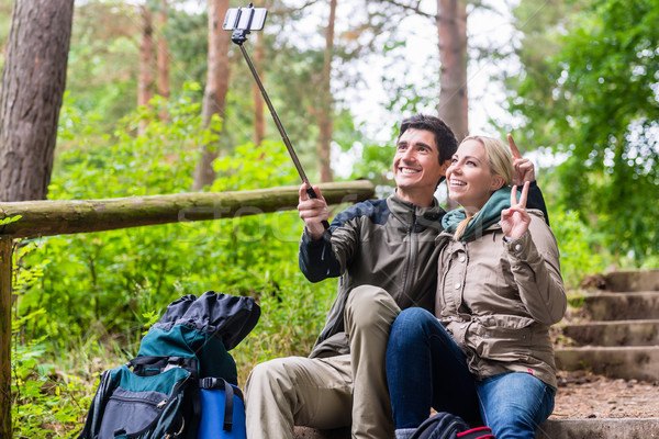 Man and woman hiking taking selfie with phone Stock photo © Kzenon