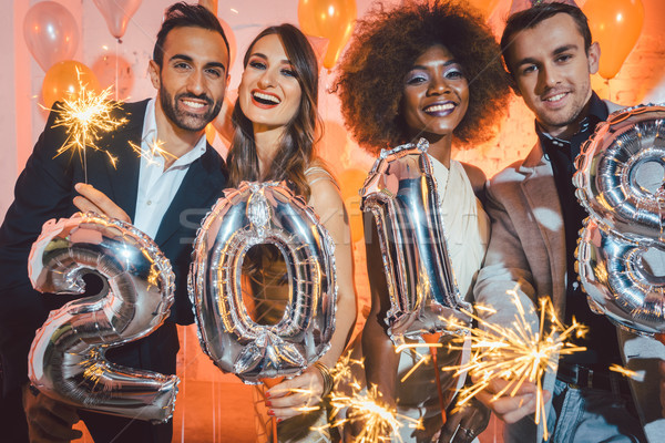 Group of party people celebrating the arrival of 2018 Stock photo © Kzenon