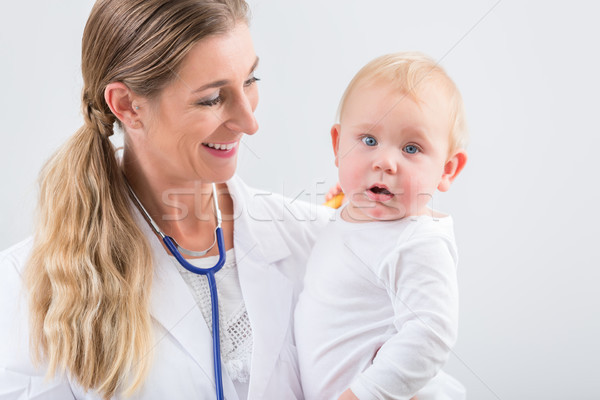 Portrait of a dedicated pediatric care specialist smiling while  Stock photo © Kzenon