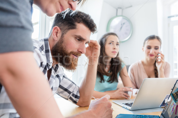 Stock photo: Self-employed young man analyzing a difficult task while working