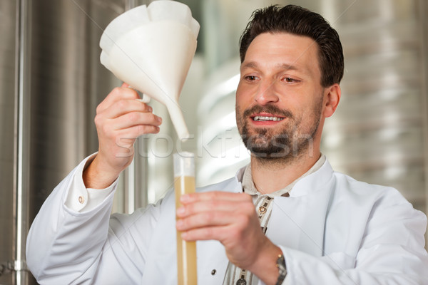 Beer brewer in his brewery examining Stock photo © Kzenon