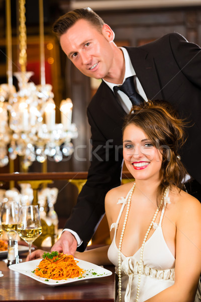 Beautiful woman and waiter in fine dining restaurant Stock photo © Kzenon