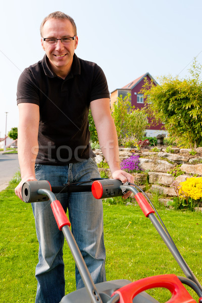 Man mowing lawn Stock photo © Kzenon
