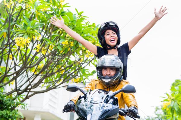 Stock photo: Indonesian woman feeling free on motorcycle