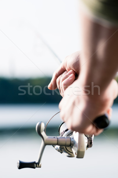 Close-up of Fisherman with fishing rod in hand Stock photo © Kzenon