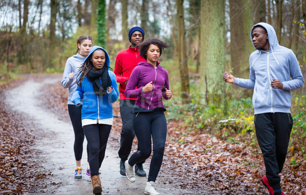 Fitness trainer guiding group of four determined young people du Stock photo © Kzenon