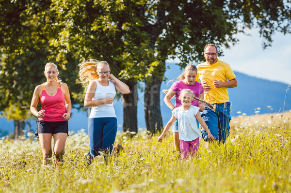 Family, mother, father and kids running for sport Stock photo © Kzenon
