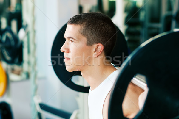 Man lifting weights in gym Stock photo © Kzenon