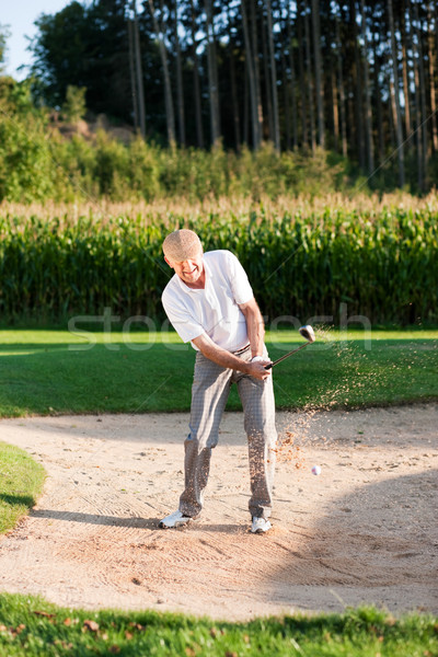 Senior golf player in sand trap Stock photo © Kzenon