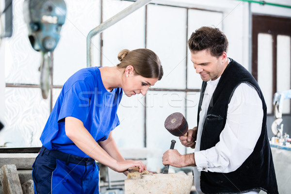 two Stonemasons carving pillar out of stone in workshop Stock photo © Kzenon