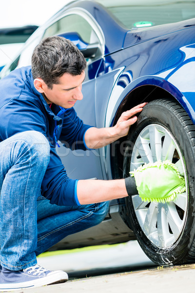 Worker using microfiber car wash mitt for cleaning rim  Stock photo © Kzenon