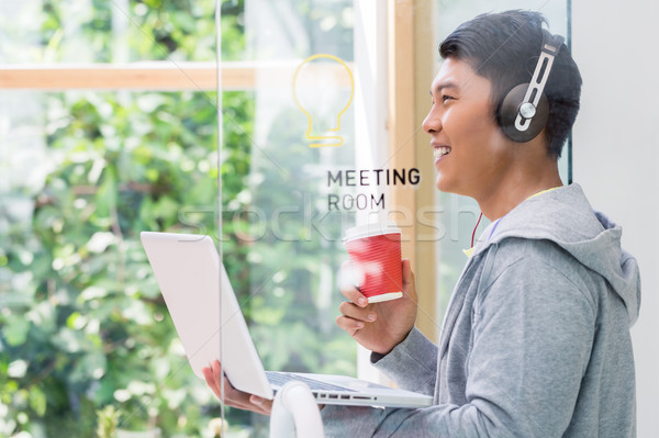 Motivated young employee smiling in the meeting room of a modern Stock photo © Kzenon