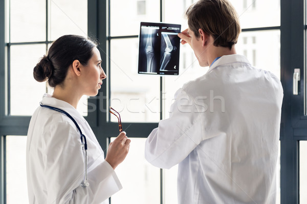Experienced orthopedist helping his colleague with the interpret Stock photo © Kzenon