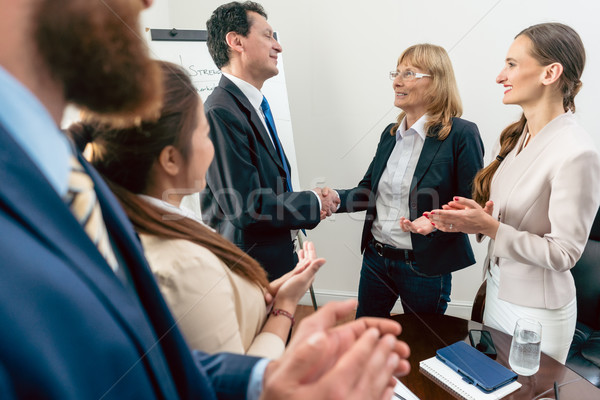Two business managers shaking hands during meeting in the confer Stock photo © Kzenon