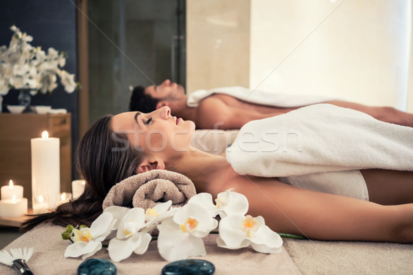 Man and woman lying down on massage beds at Asian wellness center Stock photo © Kzenon