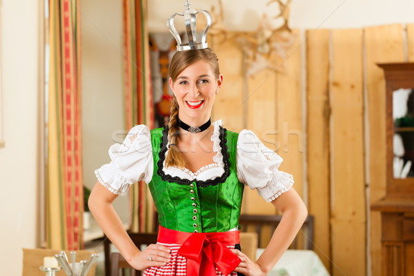 Young woman as queen in Traditional Bavarian Tracht in restaurant Stock photo © Kzenon
