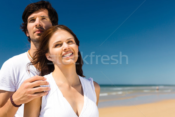 Couple enjoying freedom on the beach Stock photo © Kzenon