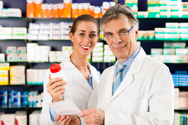 Two pharmacists in pharmacy consulting Stock photo © Kzenon