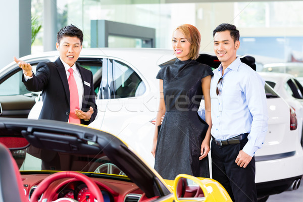 Asian couple buying car in dealership Stock photo © Kzenon