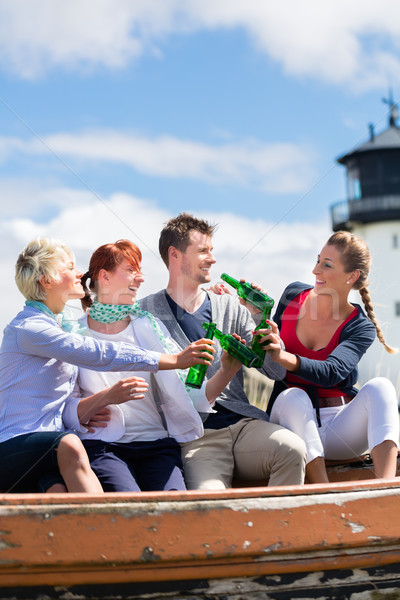 Friends drinking bottled beer at beach Stock photo © Kzenon