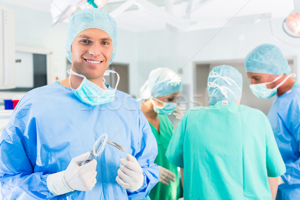 Hospital surgeons operating in operation room Stock photo © Kzenon