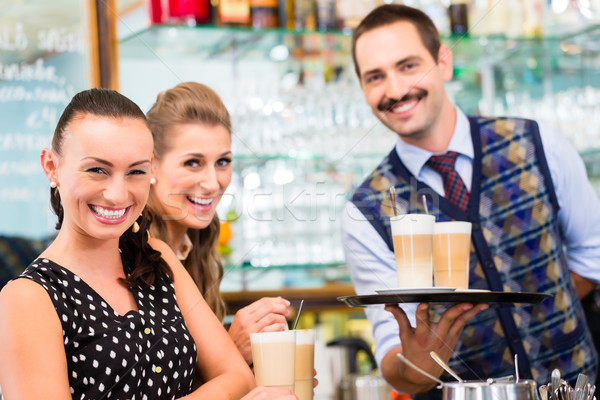 Two women friends in cafe drinking cappuccino Stock photo © Kzenon