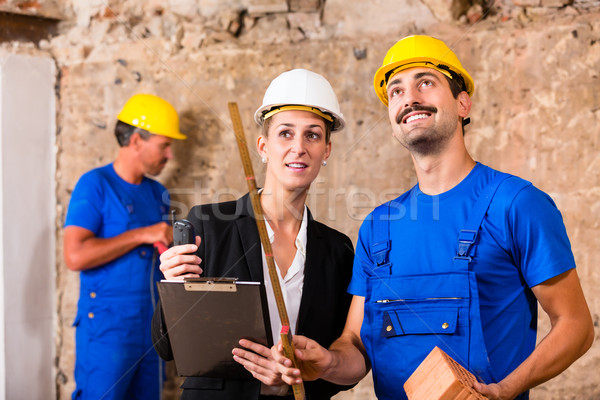 Builder and architect discussing on construction site Stock photo © Kzenon
