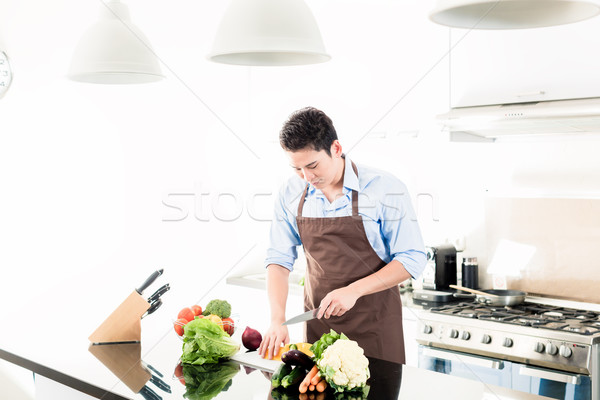 Japanese man cooking food in minimalist kitchen Stock photo © Kzenon