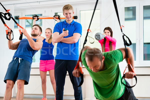 Athletes at gym during ring gymnastics with their personal train Stock photo © Kzenon