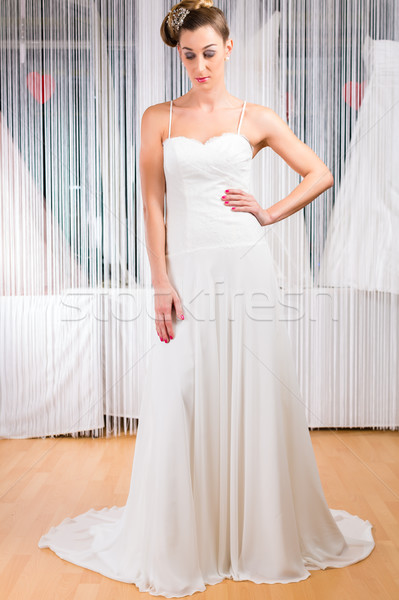 Woman trying wedding dress in shop Stock photo © Kzenon