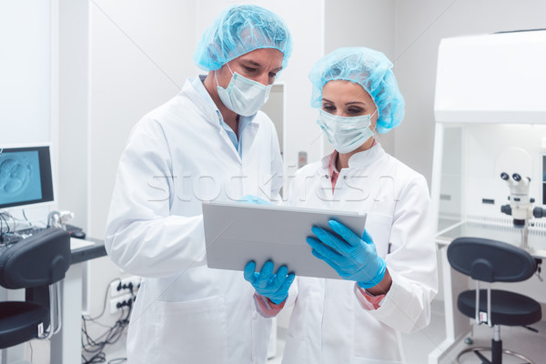 Two scientists working together in lab looking at data Stock photo © Kzenon