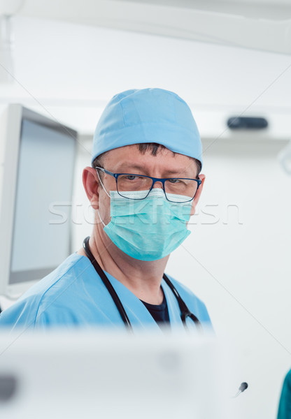 Anesthetist watching patient sleeping in operation room Stock photo © Kzenon