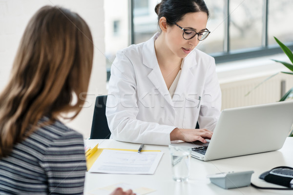 Stock photo: Primary care physician typing on laptop useful observations