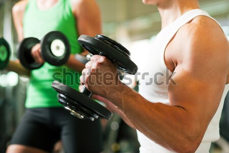 Dumbbell training in gym  Stock photo © Kzenon
