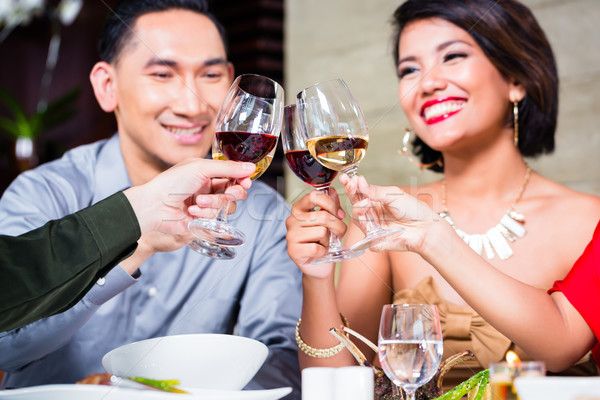 Asian friends dining in fancy restaurant Stock photo © Kzenon