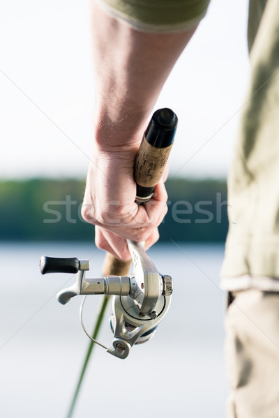 Close-up of Fisherman with fishing rod in hand Stock photo © Kzenon