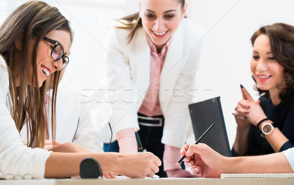 Team working together in office at planning Stock photo © Kzenon