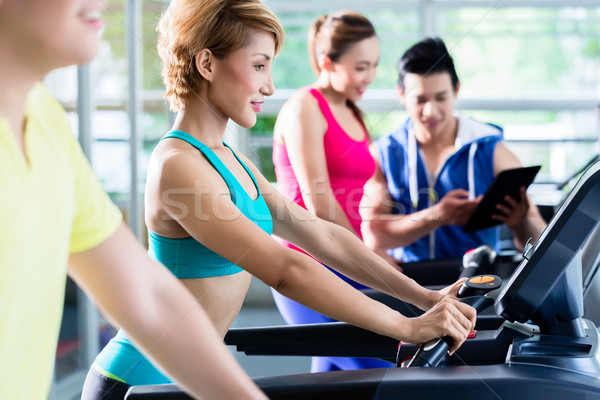 Supervision of sportive people training on treadmill Stock photo © Kzenon