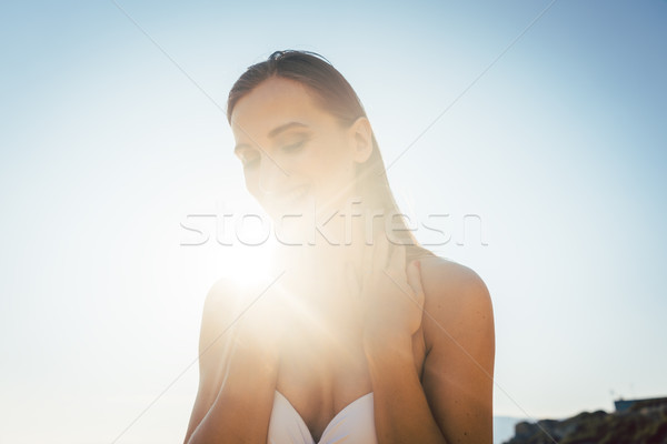 Beautiful woman enjoying sea and sun on the beach Stock photo © Kzenon