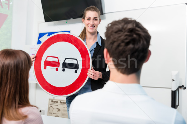 Driving instructor explaining meaning of street sign to class Stock photo © Kzenon