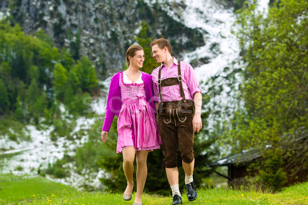 Happy couple hiking in Alpine meadow Stock photo © Kzenon