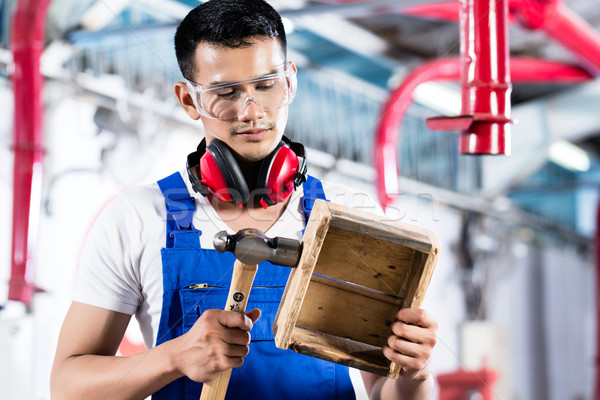 Stock photo: Asian Carpenter in wood workshop working 