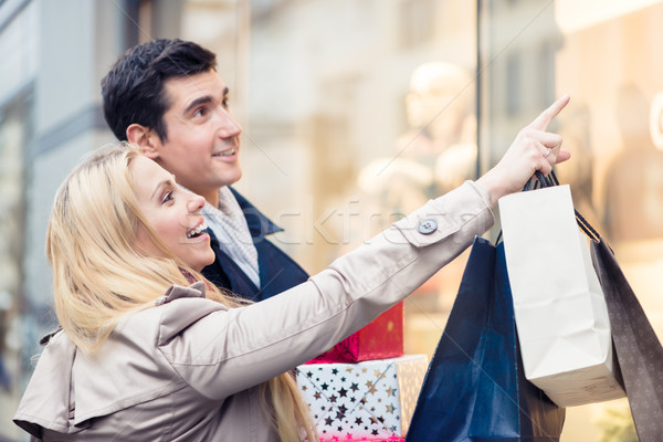 Couple at shop window doing Christmas shopping Stock photo © Kzenon