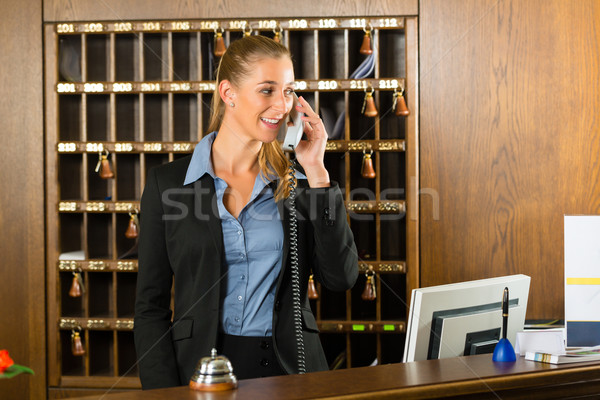 Reception Of Hotel Desk Clerk Taking A Call Stock Photo C Arne